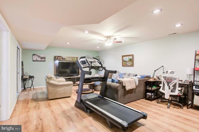 exercise area featuring ceiling fan and light wood-type flooring