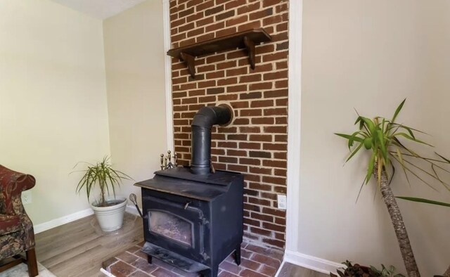 room details with wood-type flooring and a wood stove