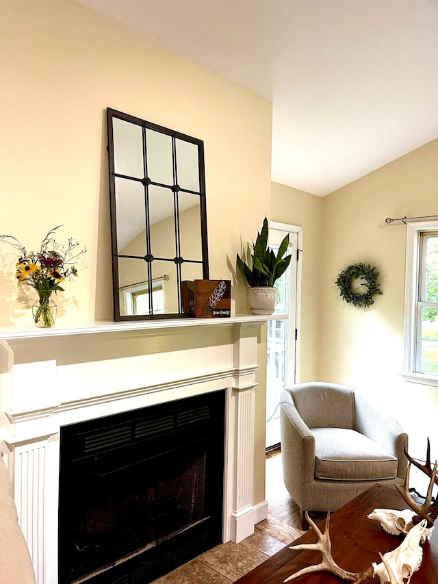 sitting room with lofted ceiling