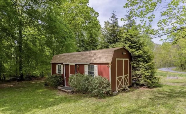 view of outbuilding with a lawn