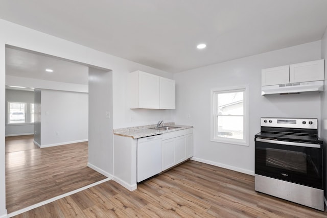 kitchen featuring light wood-style flooring, under cabinet range hood, a sink, dishwasher, and stainless steel range with electric stovetop