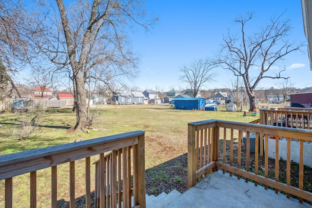 view of yard with an outdoor structure, a wooden deck, and a residential view