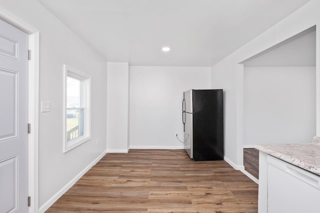 kitchen with light wood-style floors, recessed lighting, baseboards, and freestanding refrigerator