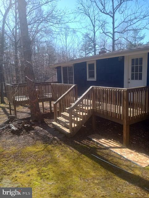 back of house with a wooden deck