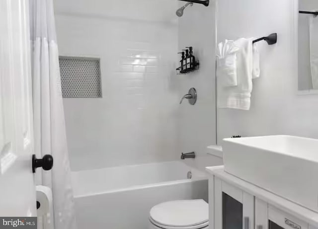 full bath with shower / tub combo, vanity, and toilet