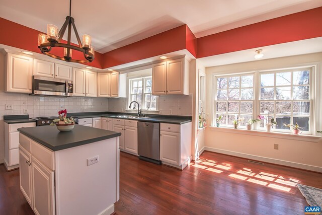 living room with french doors, ceiling fan, a brick fireplace, and a wealth of natural light