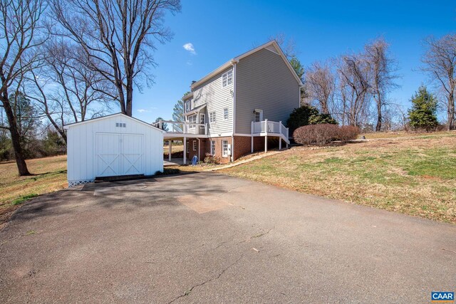 back of property with a yard, a patio, and a deck