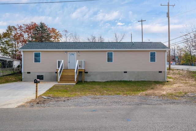 view of front of house featuring crawl space, driveway, roof with shingles, and fence