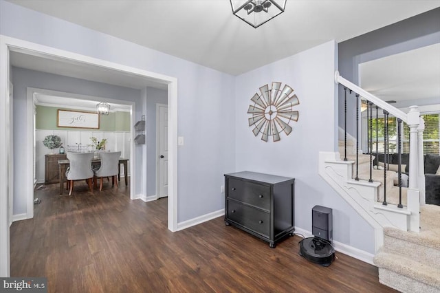 interior space with baseboards, dark wood-style flooring, and stairway