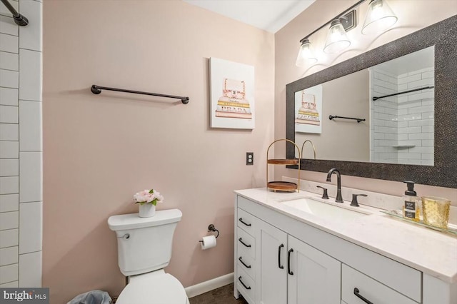 bathroom featuring vanity, baseboards, a shower, and toilet