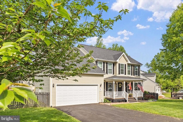 view of front of home featuring fence, an attached garage, a front yard, covered porch, and driveway
