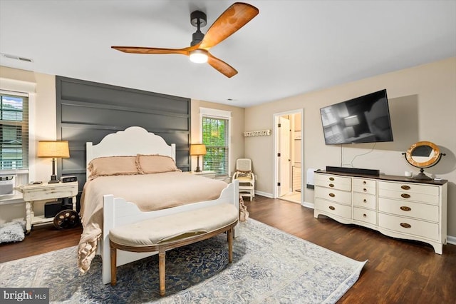 bedroom with visible vents, dark wood-style flooring, ceiling fan, and baseboards