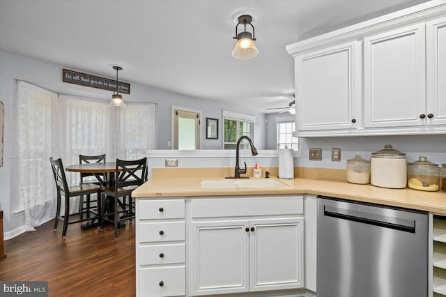kitchen with a sink, light countertops, a peninsula, white cabinetry, and stainless steel dishwasher