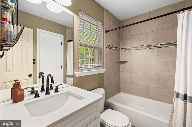 bathroom featuring vanity, toilet, and shower / tub combo with curtain
