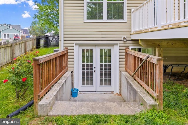 entrance to property with fence and french doors