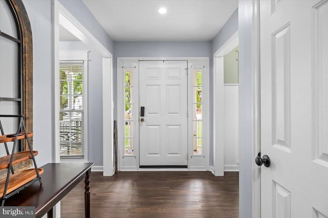 foyer entrance with dark wood-style flooring, baseboards, and recessed lighting