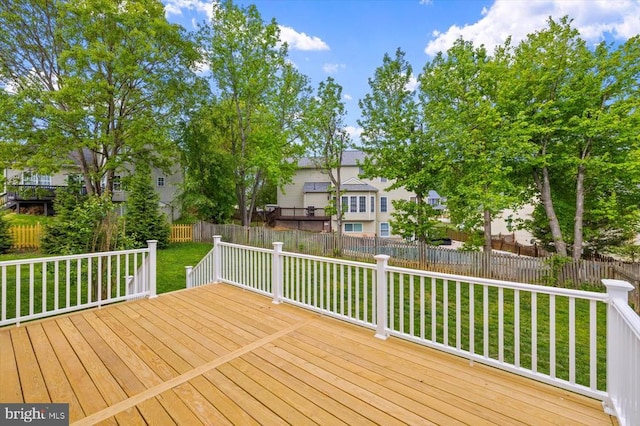 deck featuring fence and a yard