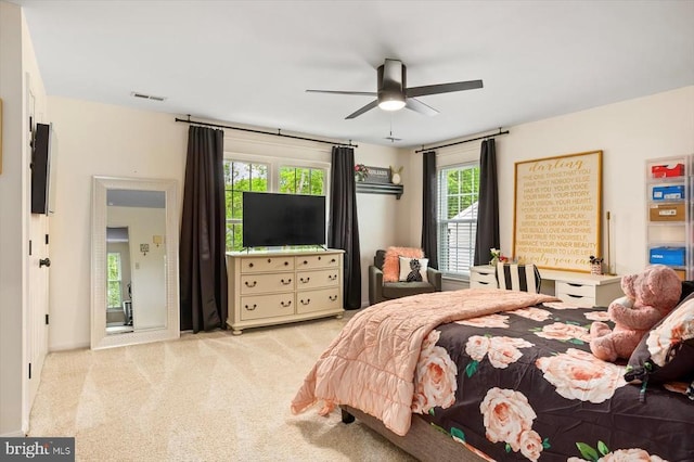 bedroom featuring carpet floors, a ceiling fan, and visible vents