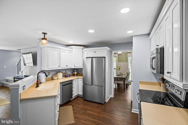 kitchen with a sink, light countertops, white cabinets, and stainless steel appliances