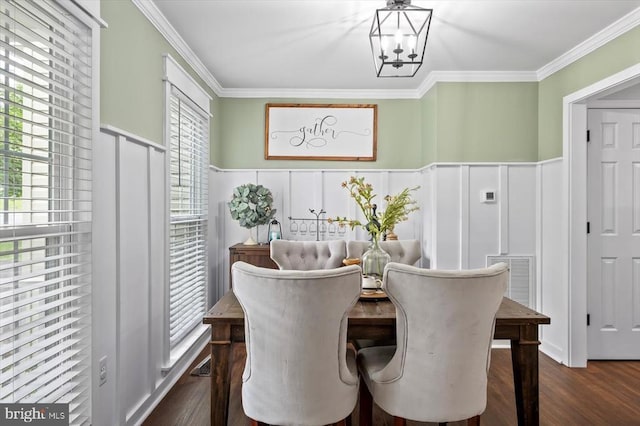 dining area with crown molding, visible vents, a decorative wall, a wainscoted wall, and dark wood finished floors