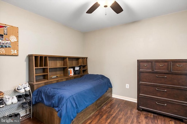 bedroom featuring baseboards, ceiling fan, and dark wood finished floors