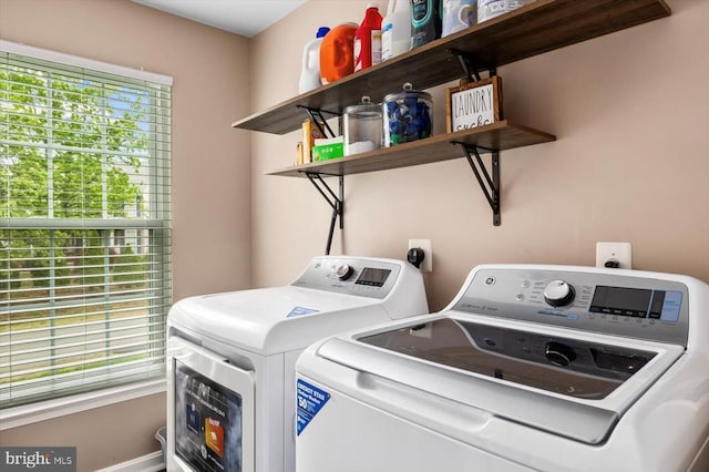 washroom featuring laundry area and washing machine and clothes dryer