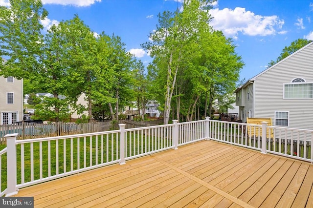 deck with a lawn and fence
