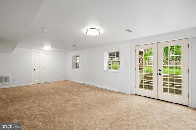 interior space featuring plenty of natural light, french doors, carpet, baseboards, and visible vents
