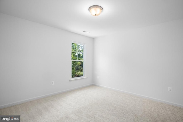 spare room with light carpet