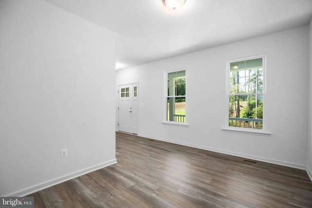 empty room with dark wood-type flooring