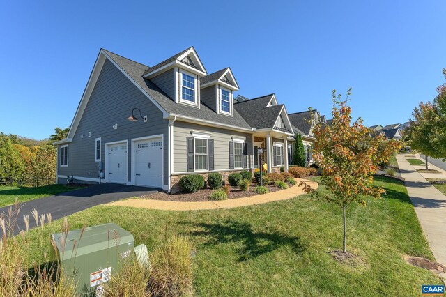 view of front of home with a garage and a front yard