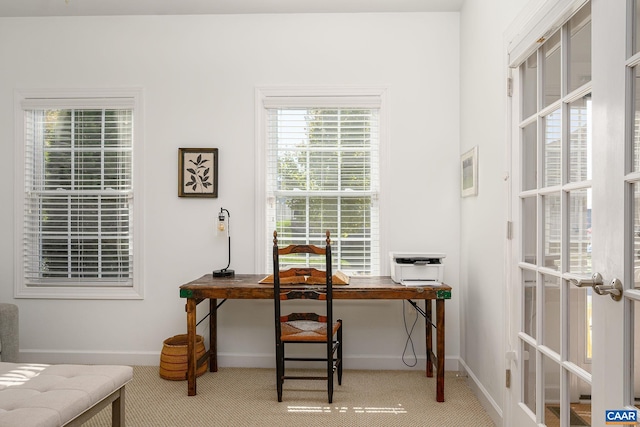 carpeted home office with french doors