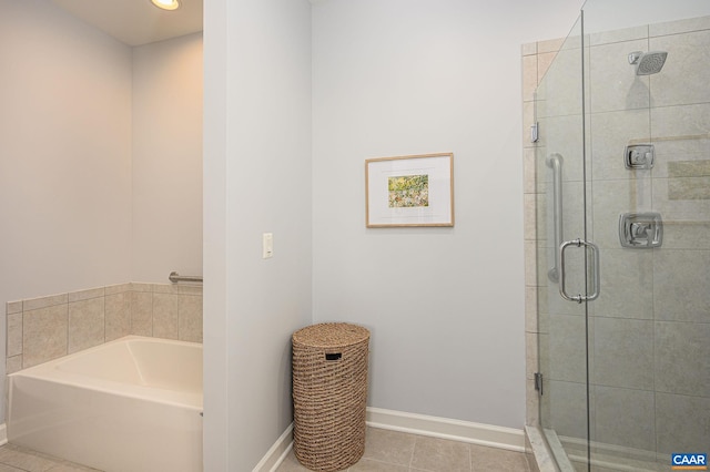 bathroom featuring shower with separate bathtub and tile patterned flooring