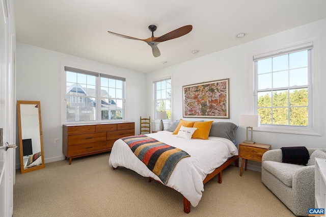 carpeted bedroom featuring ceiling fan