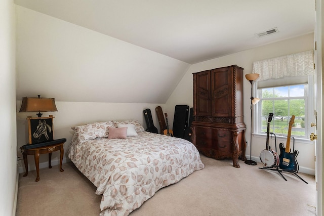 bedroom with light colored carpet, baseboards, visible vents, and lofted ceiling