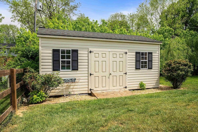 view of shed featuring fence