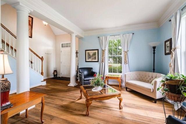 living area with light wood-style flooring, stairs, baseboards, decorative columns, and ornamental molding