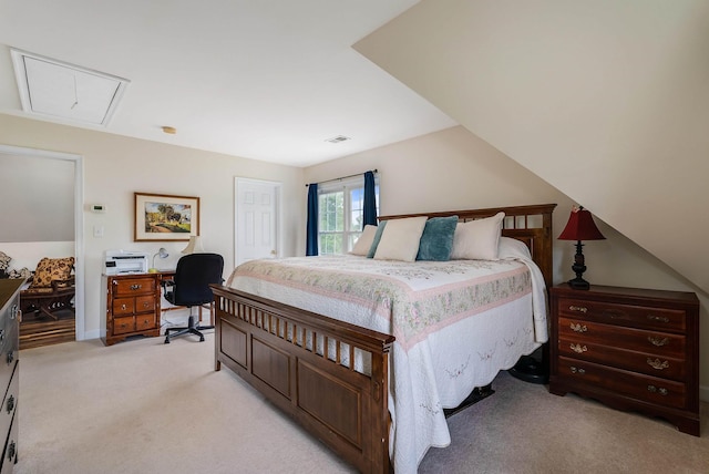 bedroom with visible vents, attic access, and light carpet