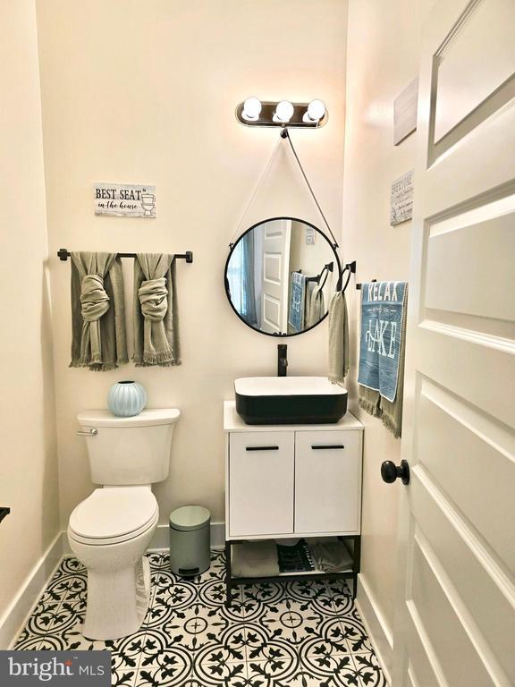 bathroom featuring tile patterned floors, toilet, and vanity