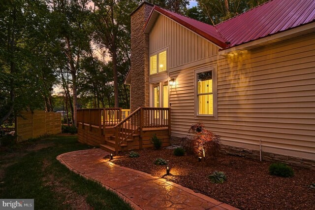 exterior entry at dusk featuring a deck