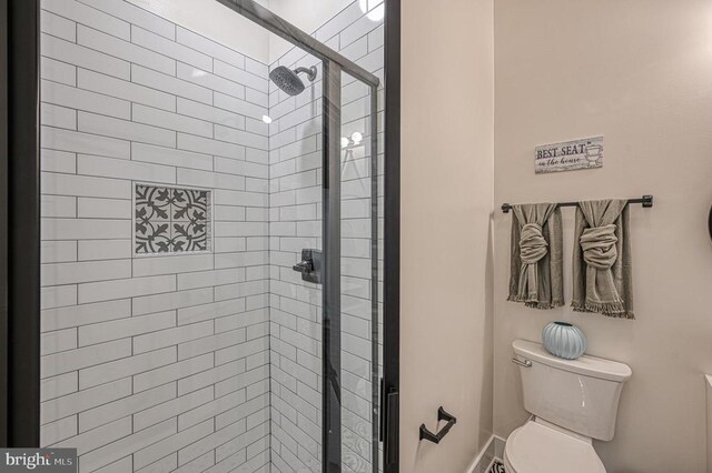 bathroom featuring toilet and walk in shower