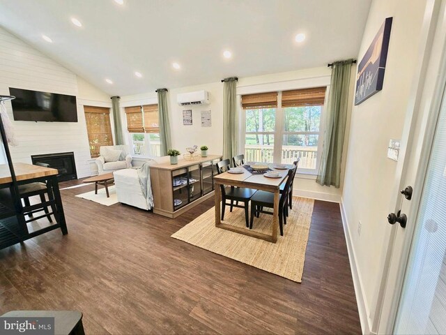 dining area with a wall mounted air conditioner, a fireplace, dark hardwood / wood-style flooring, and vaulted ceiling