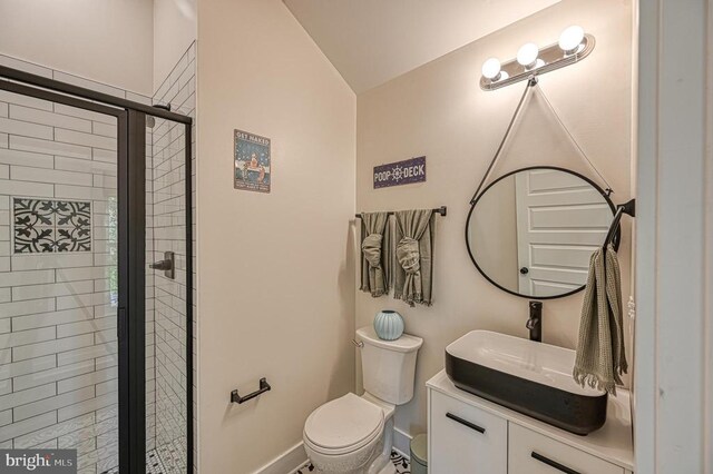 bathroom featuring vanity, toilet, and walk in shower