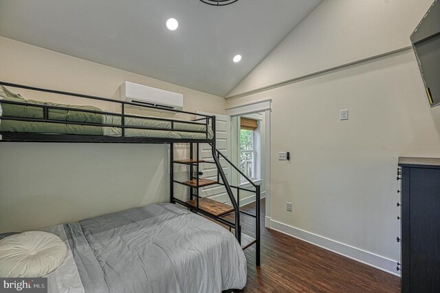 bedroom featuring lofted ceiling, dark hardwood / wood-style floors, and a wall mounted AC