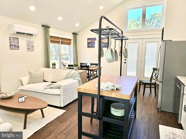 interior space featuring dark hardwood / wood-style flooring, a wall mounted AC, and high vaulted ceiling