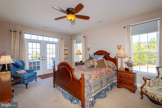 carpeted bedroom with visible vents, multiple windows, french doors, and access to outside