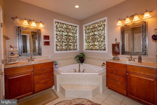 full bath featuring tile patterned floors, a bath, two vanities, and a sink