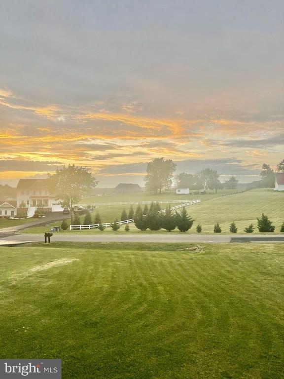 view of community featuring a yard and a rural view