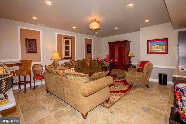 living area with recessed lighting, visible vents, and baseboards