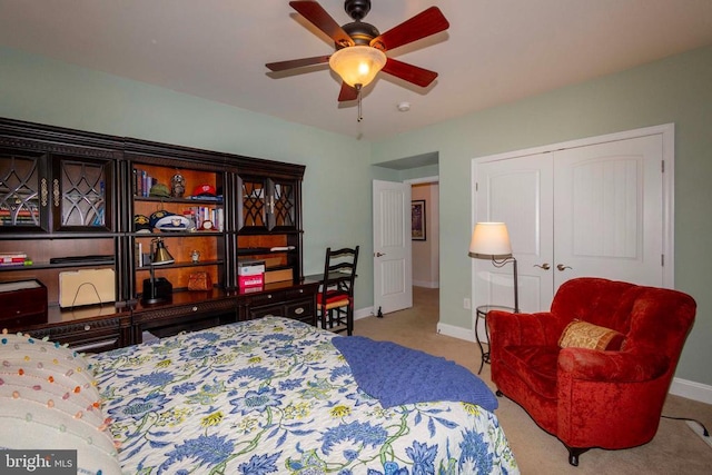 bedroom featuring a ceiling fan, baseboards, a closet, and carpet floors